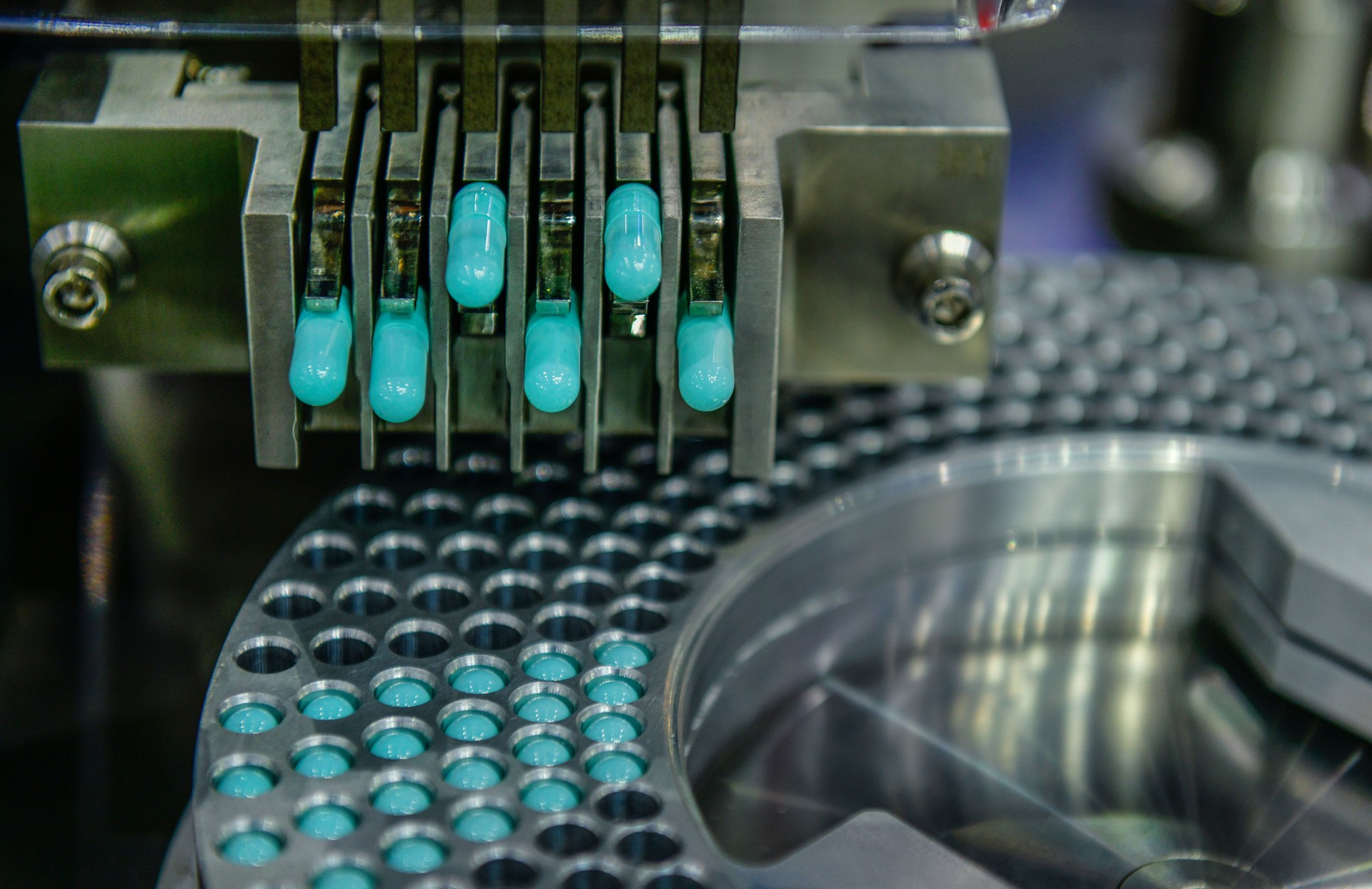 Industrial production line manufacturing medication capsules for pharmaceutical companies