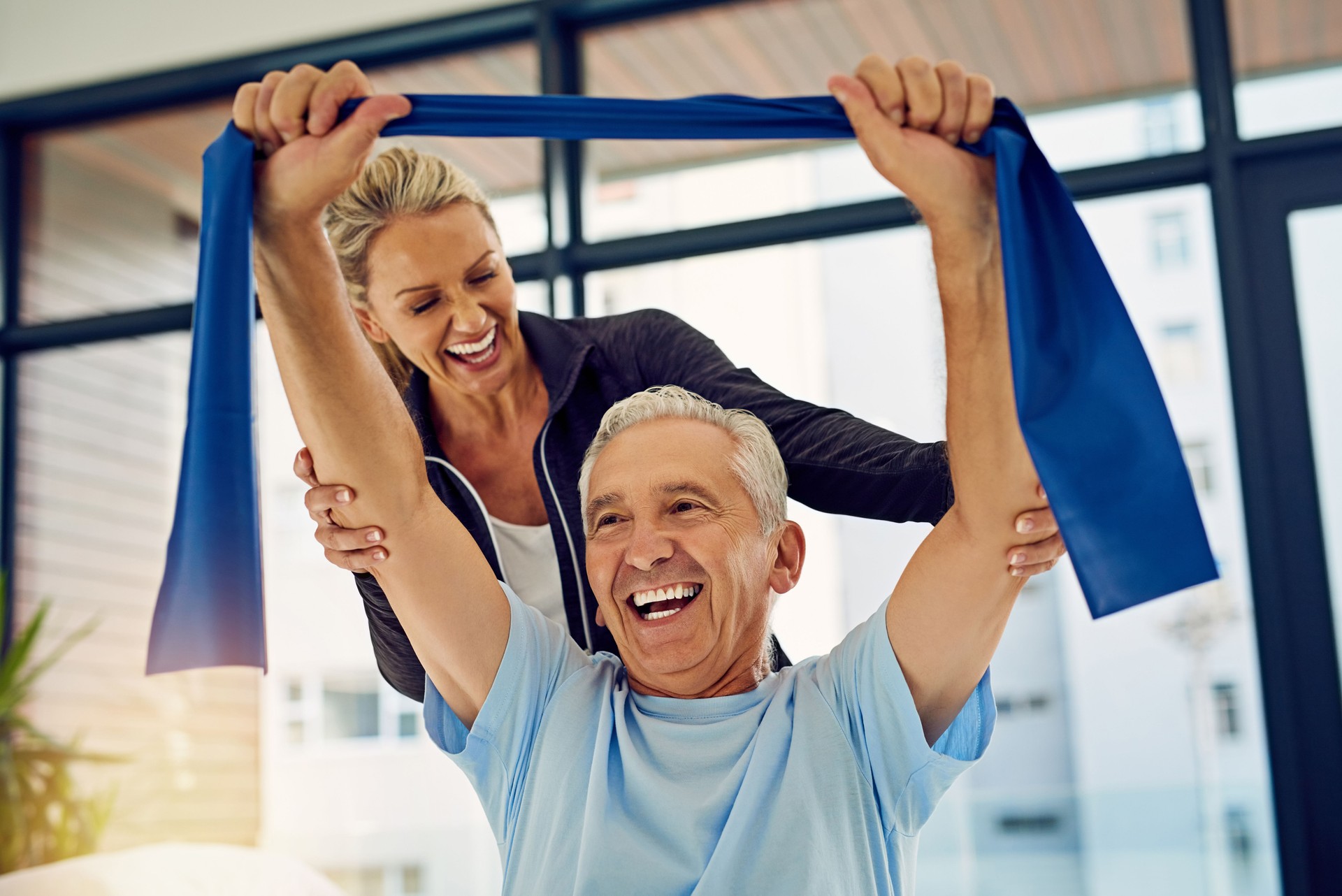 Physiotherapist supporting client with functional exercises